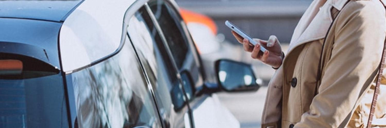 Woman charging electric vehicle